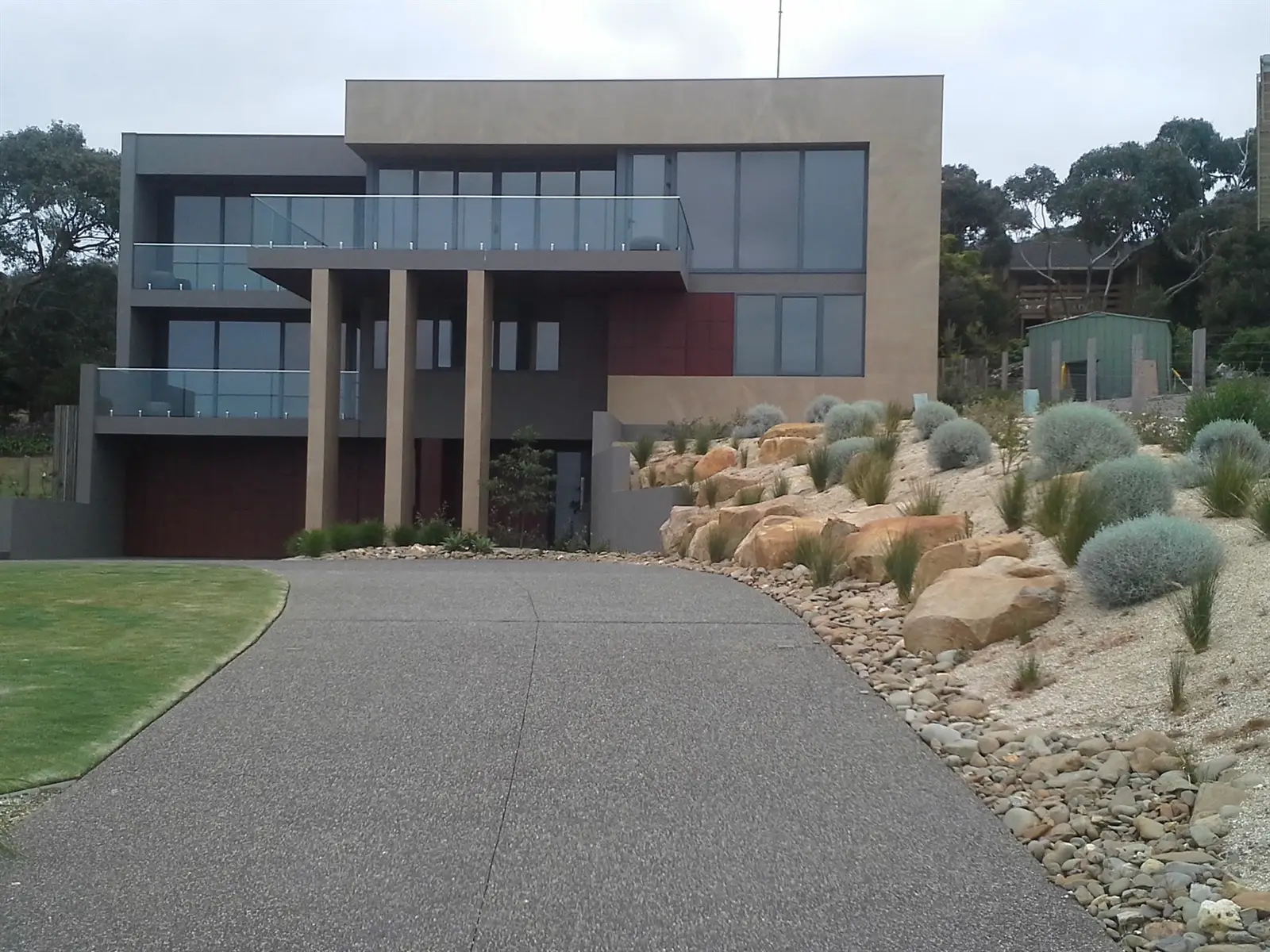 View of coastal garden and driveway plantings