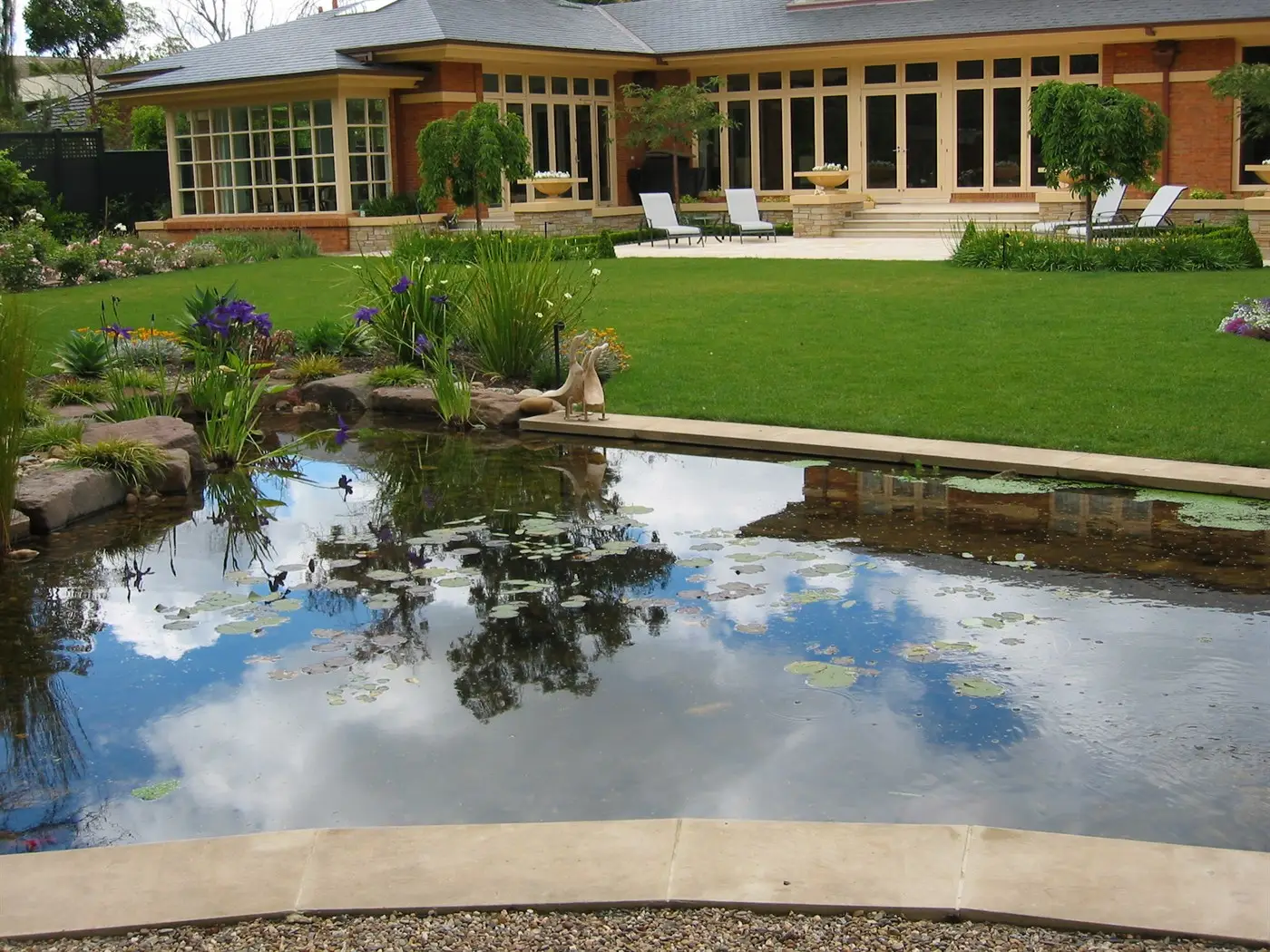 Looking across pond and lawn to house